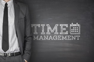 Time management on black blackboard with businessman